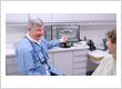 Dr. Alan Brodine reviews a digital dental scan with a patient during a personalized prosthodontic consultation in Rochester, NY