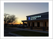 Comprehensive Dentistry's illuminated sign at sunset marking your premier dental implant destination in Saline, MI