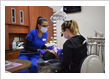Dental team performing a tooth restoration procedure under magnification loupes at Roman Dental Arts in Hackensack, NJ