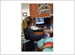 Dental hygienist performing an intraoral camera exam for digital dental X-rays and diagnostics at Roman Dental Arts in Hackensack, NJ