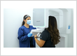 Dental assistant positioning a patient for a panoramic X-ray scan at Diamond Dental Group Dr. Alex Katanov