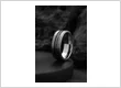 The Celestial Legacy tungsten ring featuring a crushed red T Rex bone and meteorite inlay.