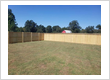 Cedar Wood Fence Installation Near Barn