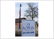 Roman Dental Arts outdoor sign and toothbrush flagpole landmark for the family dental office in Hackensack, NJ