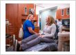 Dental hygienist consulting with a patient before a preventive care visit at Roman Dental Arts in Hackensack, NJ
