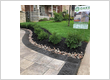Front yard landscaping by Oaks Home Services near a residential home