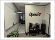 Open iT branded office space with a whiteboard, coffee station, and water cooler.