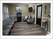 Comfortable patient waiting room with aquarium at Roman Dental Arts, a family dentistry practice in Hackensack, NJ